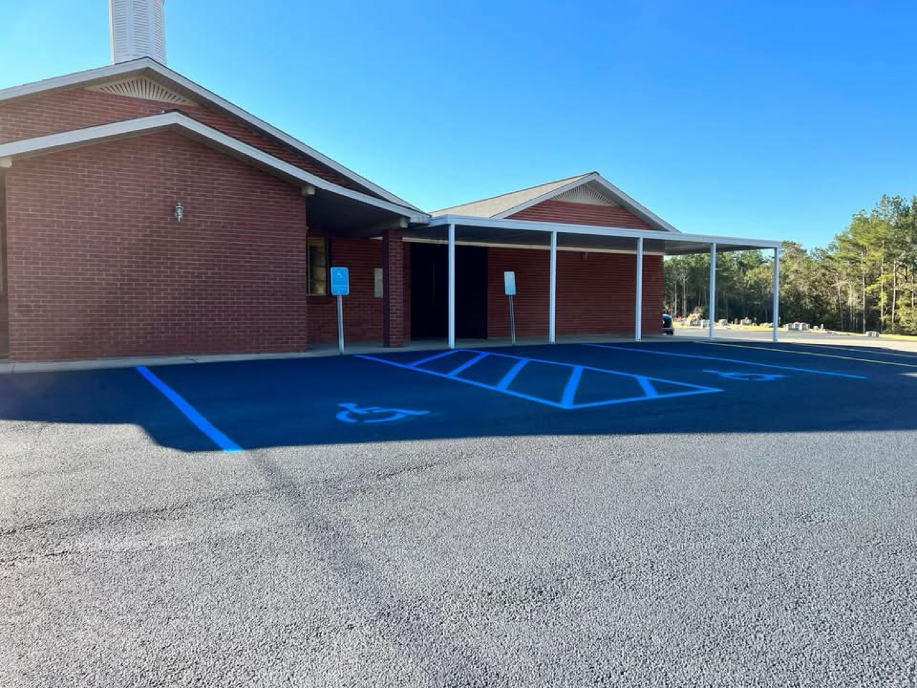 ADA handicap parking spaces with fresh blue striping